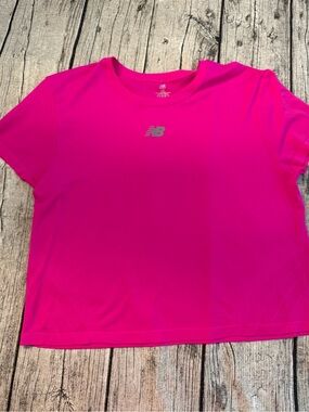 NEW. New Balance cropped work out tee. New, never used. Dry breathable fabric
